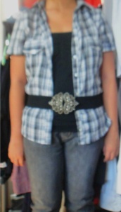 checked grey blouse with jeans and black top and belt